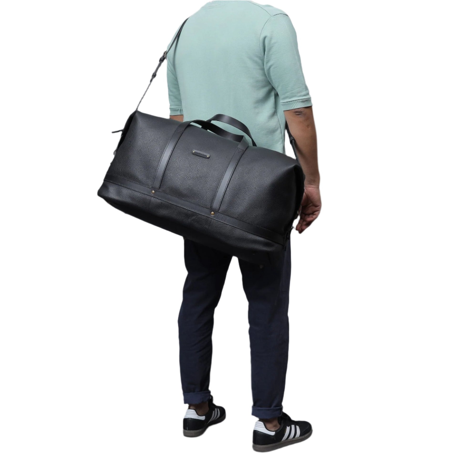 Gentleman carrying stylish and spacious black leather duffel bag/weekender